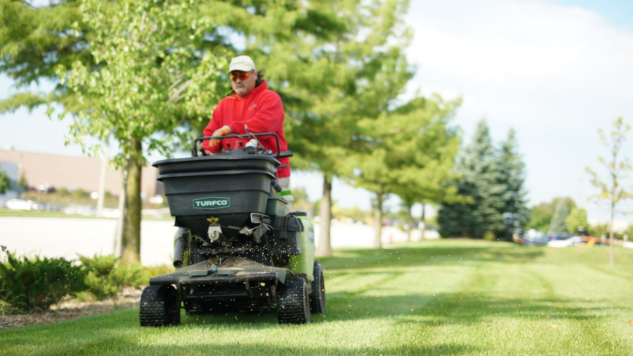 Person on Fertilizer Spreader Commercial Landscape Maintenance